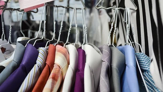 Freshly cleaned shirts on hangers at Caché Cleaners
